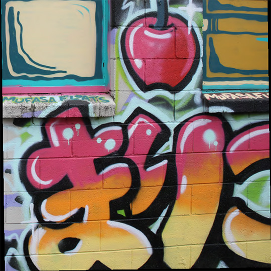 A cropped frame of street art with a stylised illustration of an apple and Japanese hiragana letters.